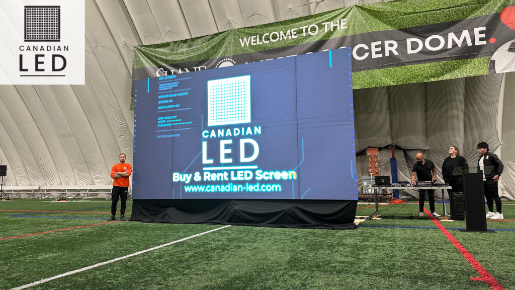 LED screen setup by Canadian LED inside a sports dome with crew members and technician on standby.