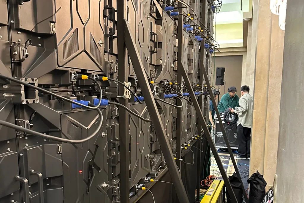 Backside view of LED video wall installation with wiring and setup crew