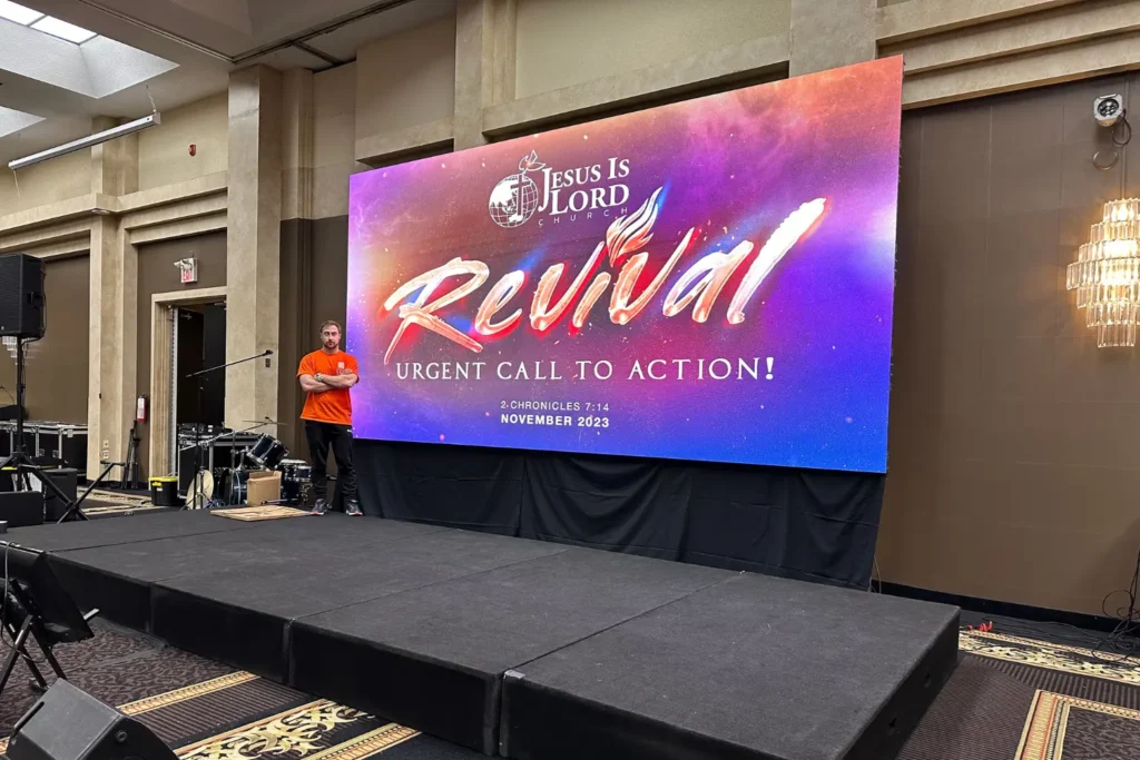 Canadian LED event LED wall installation for church revival conference with stage setup and technician on site.